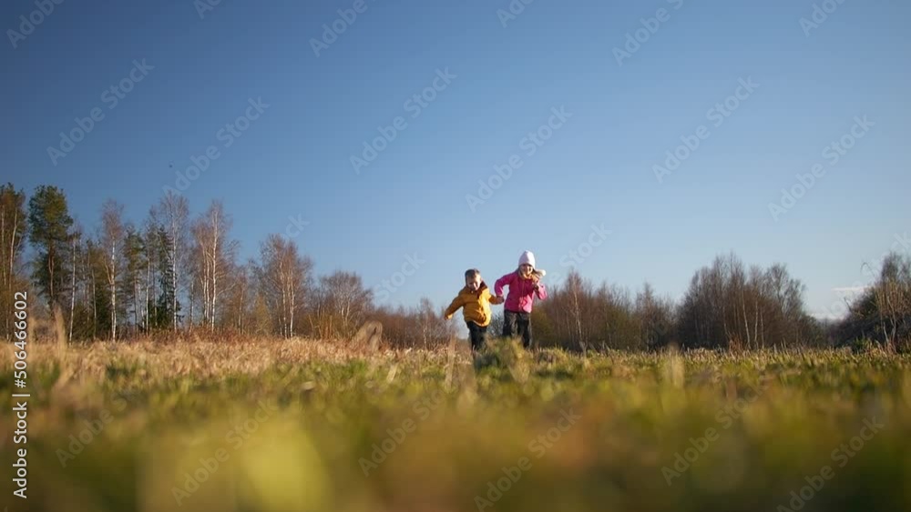 Kisd run on agriculture field on sunny day, slow motion low angle view Kisd run on agriculture field on sunny day, slow motion low angle view