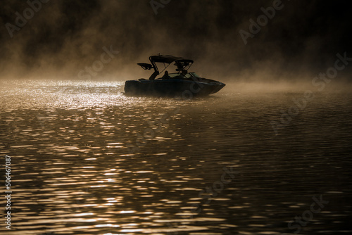 beautiful view of water and boat in the early morning fog