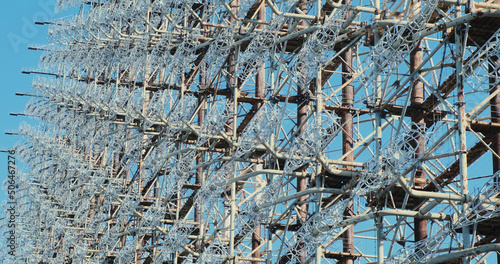 Radio antenna Soviet woodpecker, cold war. Giant metal structure for military purposes. Abandoned heritage of the USSR. photo