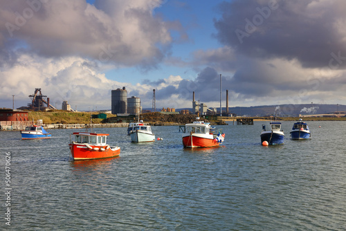 Landscape image showing fishing boats and industry at South Gare on Teesside near Middlesbrough, North Yorkshire, England, UK. photo