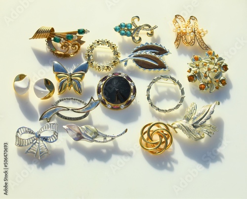 Collection display of vintage jewelry brooches bracelets earrings costume jewelry accessory photo