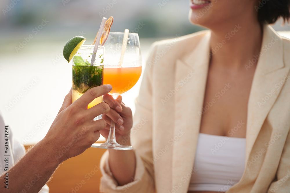 Closeup image of party guests toasting with glasses of sweet delicious cocktails Closeup image of party guests toasting with glasses of sweet delicious cocktails