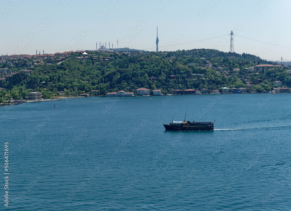 Black touristic travel ferry on the bosphorus sea