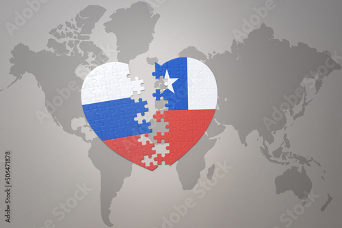 puzzle heart with the national flag of russia and chile on a world map background. Concept.
