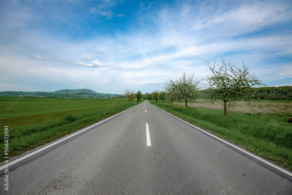 road in the mountains between the fields