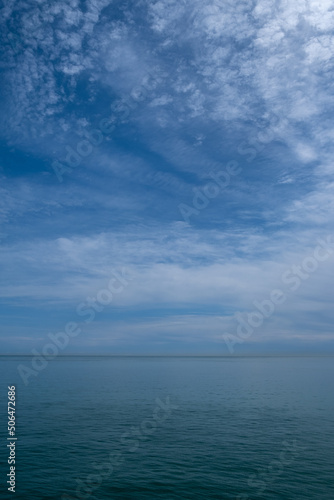 The empty sea under a blue cloudy sky