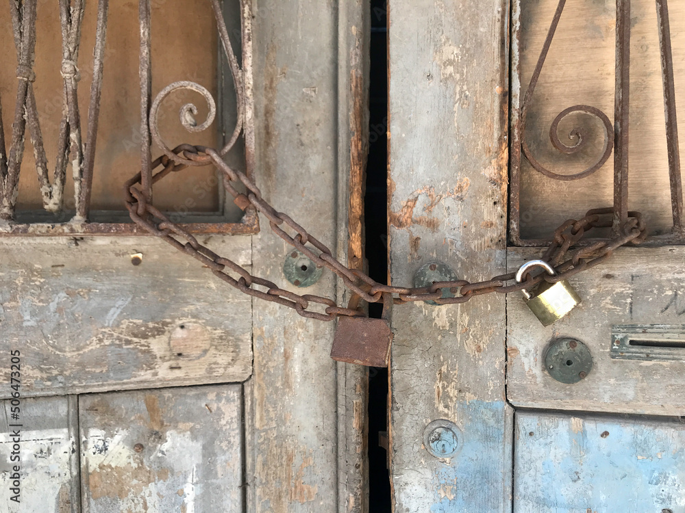 Chain locked door of an abandoned house Chain locked door of an abandoned house