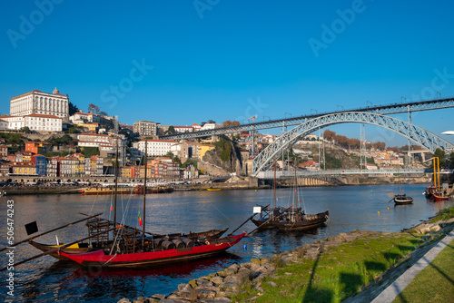 Oporto traditional boats, anchored on the Douro River, view from Vila Nova de Gaia City side with the cityscape of Porto city as Background.