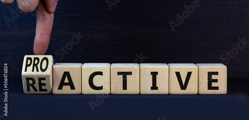 Reactive or proactive symbol. Turned wooden cubes and changed the concept word reactive to proactive. Beautiful grey table grey background, copy space.Business and reactive or proactive concept. photo