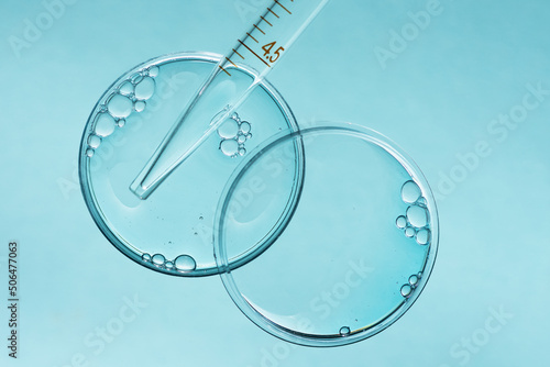 Laboratory Petri dishes with liquid and pipette. Abstract scientific research concept.