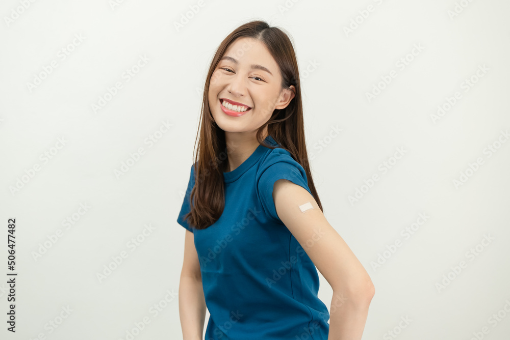 Happy Asian woman showing his arm and bandage after they get a vaccine. Happy Asian woman showing his arm and bandage after they get a vaccine.