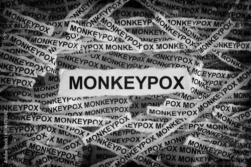 Strips of newspaper with the word Monkeypox typed on them. Monkeypox is an infectious disease caused by the monkeypox virus. Black and white. Close up. photo