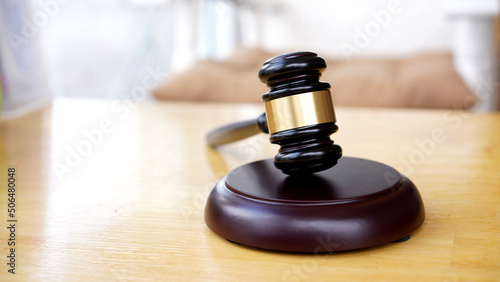 Lawyer or judge's hammer in the court. Auction's hammer is on woo table. Law subject.