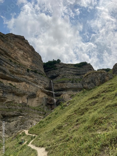 Water that flows from the mountain in one word waterfall