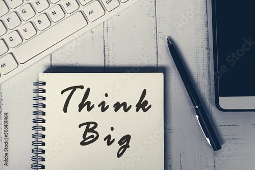 Fotografía Think big word on a notebook with white keyboard, pen, notepad and smartphone