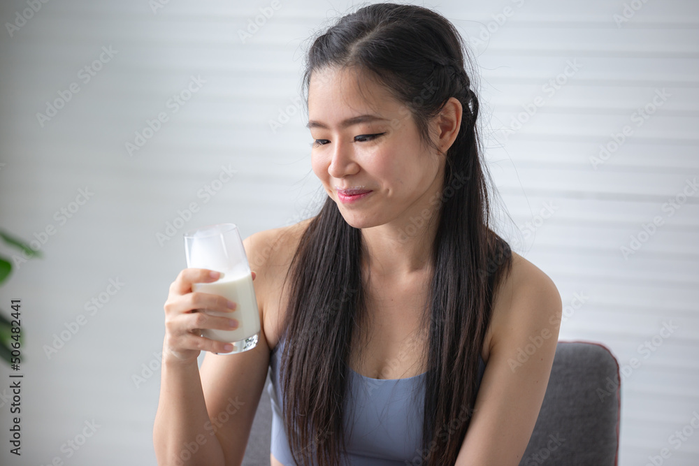 young beautiful woman person are drinking a fresh milk for body health care, smile girl holding glass of milk by happy attractive lifestyle at home, dairy breakfast product having calcium young beautiful woman person are drinking a fresh milk for body health care, smile girl holding glass of milk by happy attractive lifestyle at home, dairy breakfast product having calcium