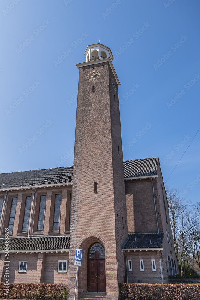 View of Kerk De Bron (De Bron Church). Kerk De Bron - three-aisled church with a 35-meter square bell tower. Amsterdam, the Netherlands.