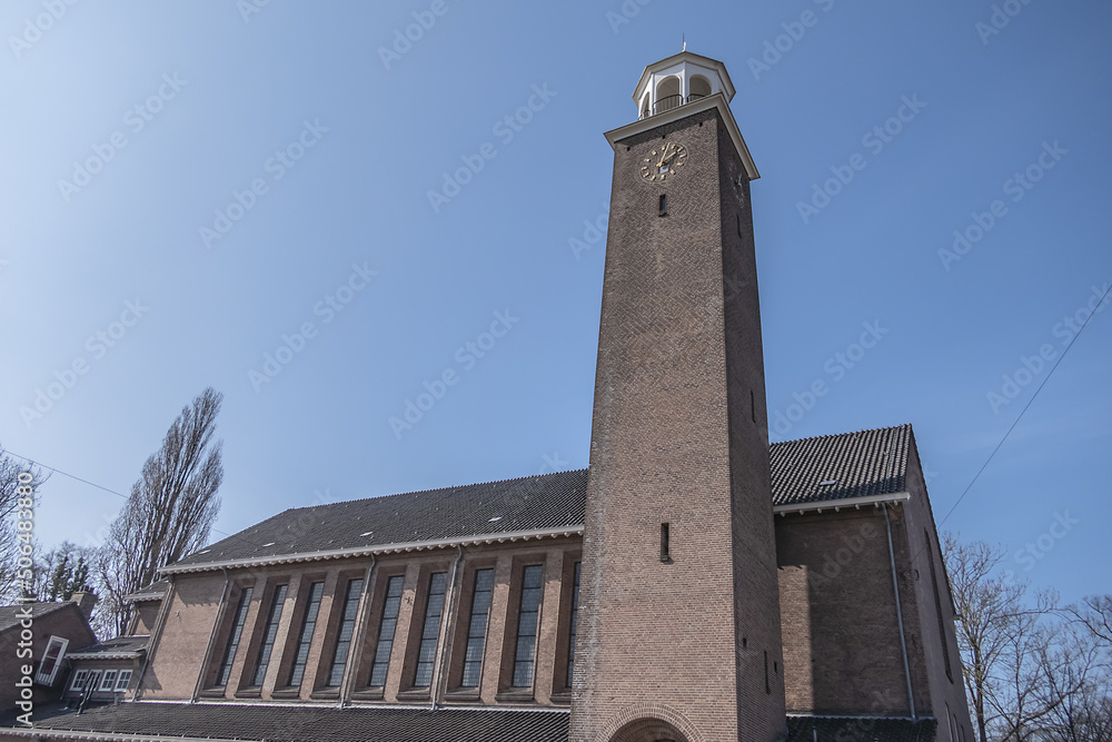 View of Kerk De Bron (De Bron Church). Kerk De Bron - three-aisled church with a 35-meter square bell tower. Amsterdam, the Netherlands.