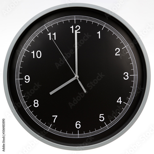 Wall clock showing eight o'clock isolated on white background