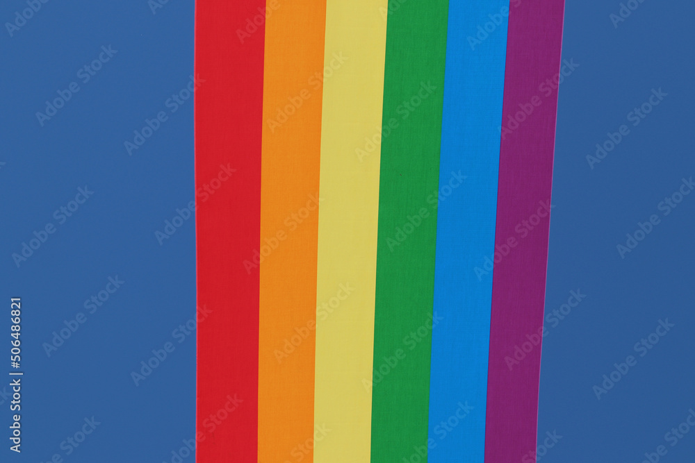 Rainbow backgrounds fabric. Closeup of rainbow linen canvas with colorful textured prallel vertical lines fabric macro. Outdoor LGBT background image.