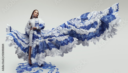 Woman in long woderful flying dress with blue and white waves photo