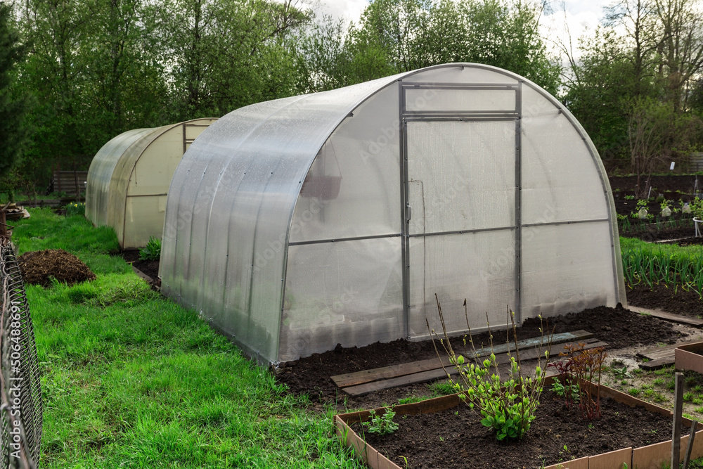 greenhouse in the garden. Greenhouse made of polycarbonate greenhouse in the garden. Greenhouse made of polycarbonate