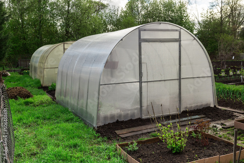 greenhouse in the garden. Greenhouse made of polycarbonate © Mieszko9