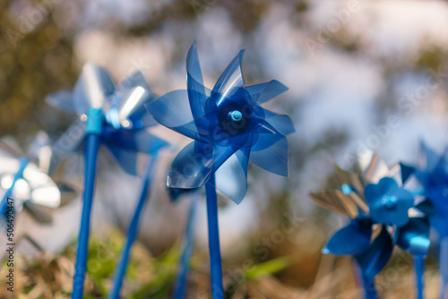 Obraz na płótnie Close up of bright blue pinwheels which are a symbol commemorating National Child Abuse Prevention Month