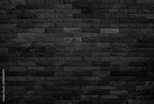 black brick wall background, dark stone texture. 