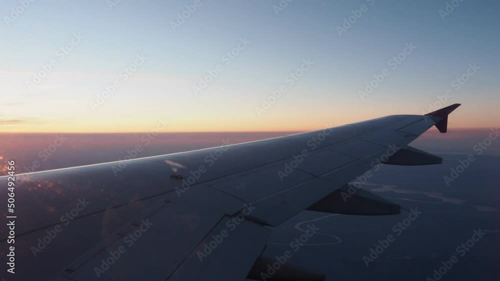 Wing of airliner in flight during beautiful sunset. Wing of airliner in flight during beautiful sunset.