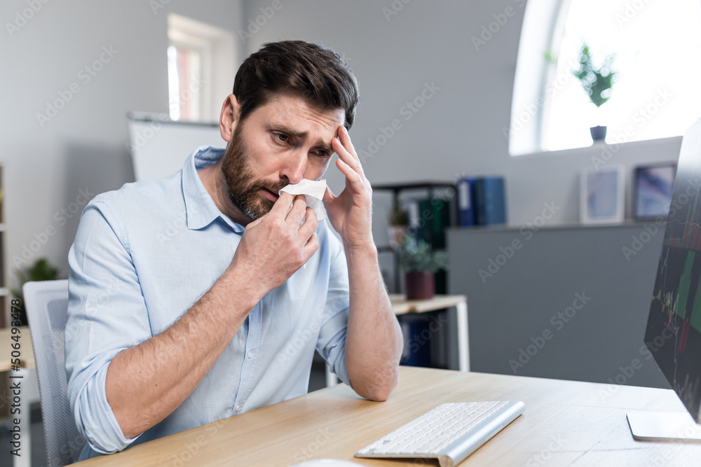 Sick and tired young man at work. Office worker, manager, freelancer ...