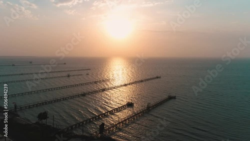 Beach with Docks Sunrise Ocean Drone Aerial Palm Trees Gulf of Mexico