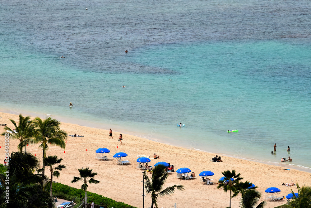 Vacationers on a beautiful beach in Hawaii.