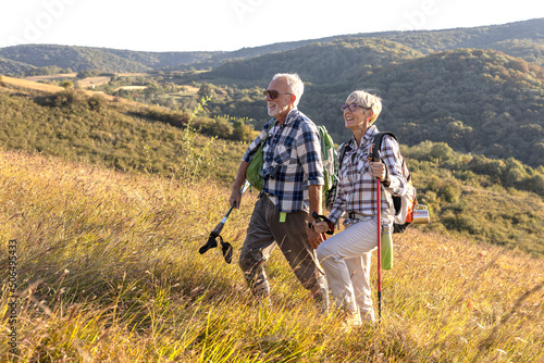 Active old woman and man walking at field and enjoy