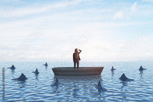 Strategy, leadership and competition concept with back view on businesswoman looking In the distance in a boat in the sea with sharks