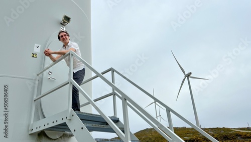 ENERGY EFFICIENT WIND POWER, WIND POWER PLANTS, WIND TURNS handsome European man nearby © Oleksandra