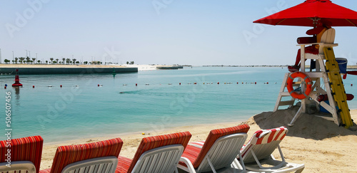 Beach with chairs and lifeguard