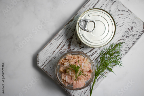 Canned fish, jar, dill on a light background tuna