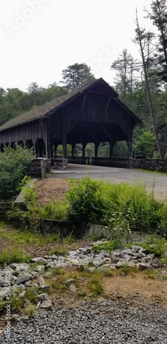 wood covered bridge crossing the river