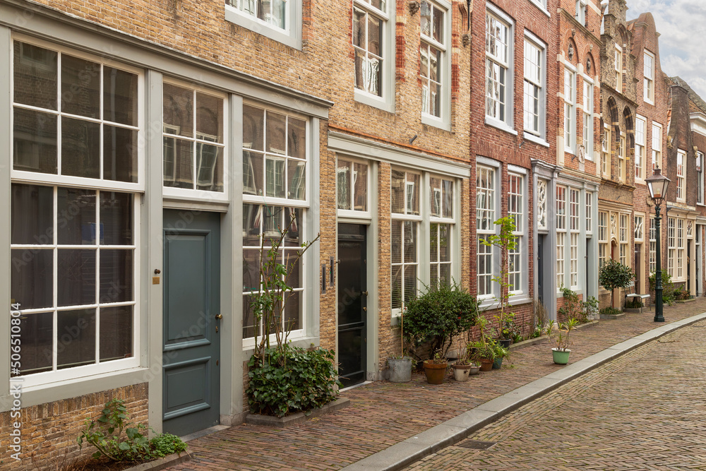 Street with old houses with different facades in the center of the historic city of Dordrecht.