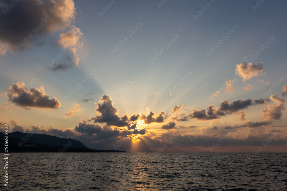 Sunset at sea, with clouds of yellow and orange tones Sunset at sea, with clouds of yellow and orange tones