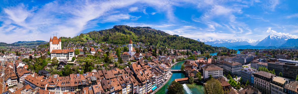 Splendid aerial panorama of Thun old town with medieval castle and Alps mountains on background. Incredible beautiful Switzerland.