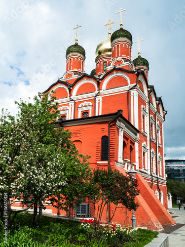 red orthodox church with a beautiful white pattern and a black dome
