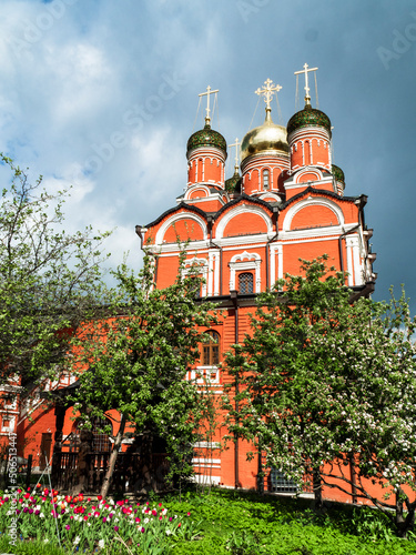 red orthodox church with a beautiful white pattern and a black dome