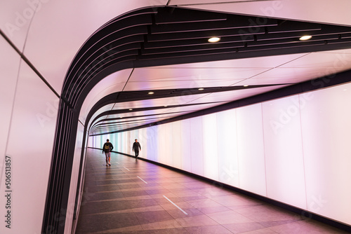 Commuters in Kings Cross light tunnel photo