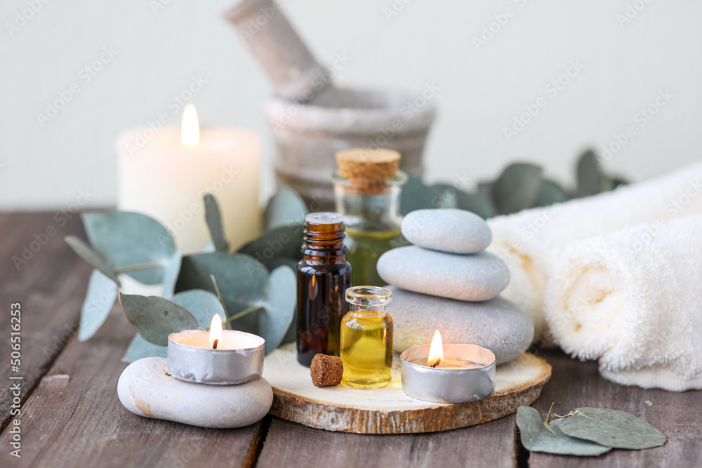 Assortment of natural oils in glass bottles on wooden background. Concept of pure organic ingredients in cosmetology. Bath accessories, atmosphere of harmony, relax. Close up macro. Healthy lifestyle Assortment of natural oils in glass bottles on wooden background. Concept of pure organic ingredients in cosmetology. Bath accessories, atmosphere of harmony, relax. Close up macro. Healthy lifestyle