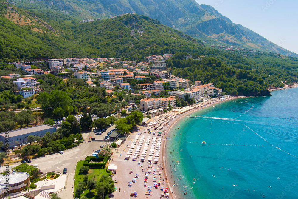 Montenegro. Adriatic Sea. Beach of Sveti Stefan. Summer. Sunny weather. High season. A very popular tourist spot. Drone. Aerial view