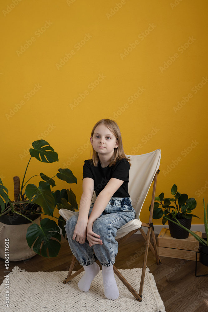 Happy child smiling and looking at camera in yellow studio Happy child smiling and looking at camera in yellow studio