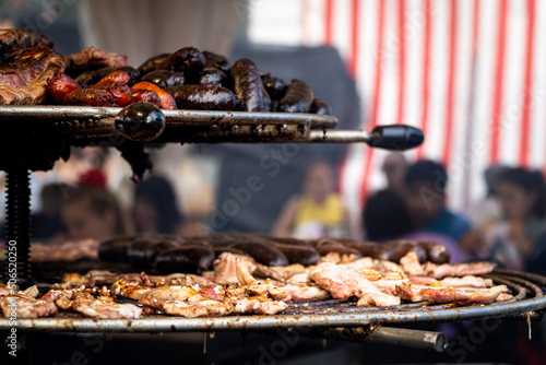Madrid,Spain;05152022:barbecue with chorizo, black pudding and bacon at an outdoor fast food stall at the san isidro festivities in madrid, spain photo