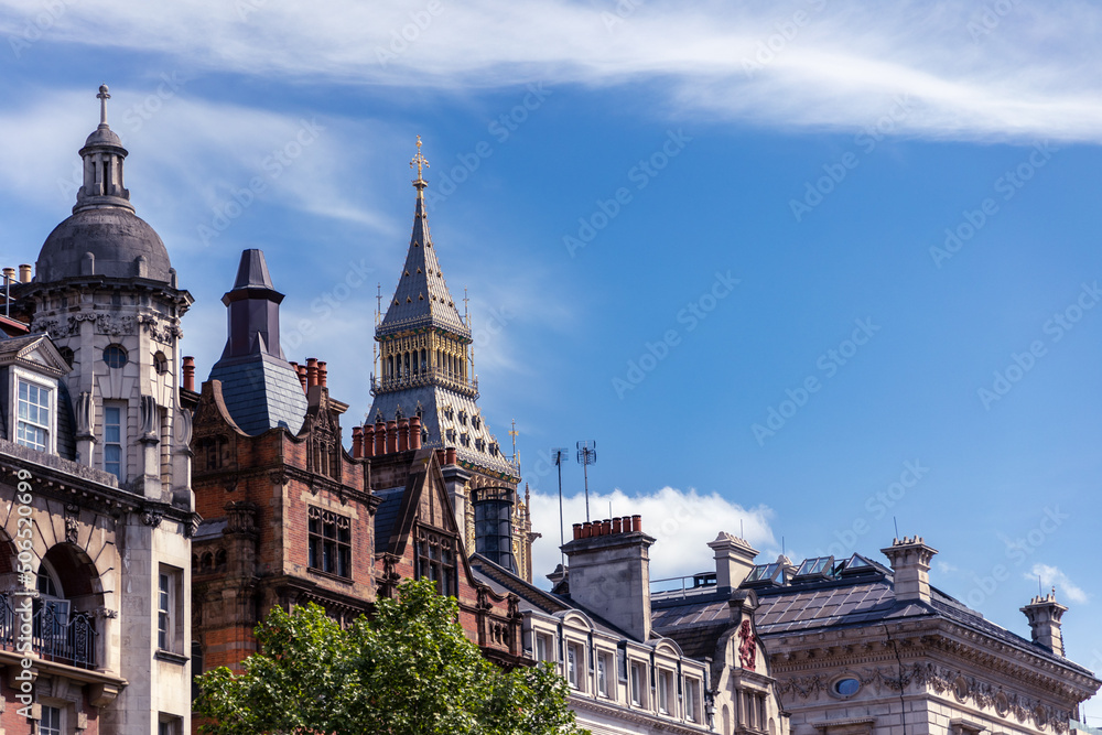 Big Ben Clock Tower seen above typical city horizon and old roofs in London, Great Britain